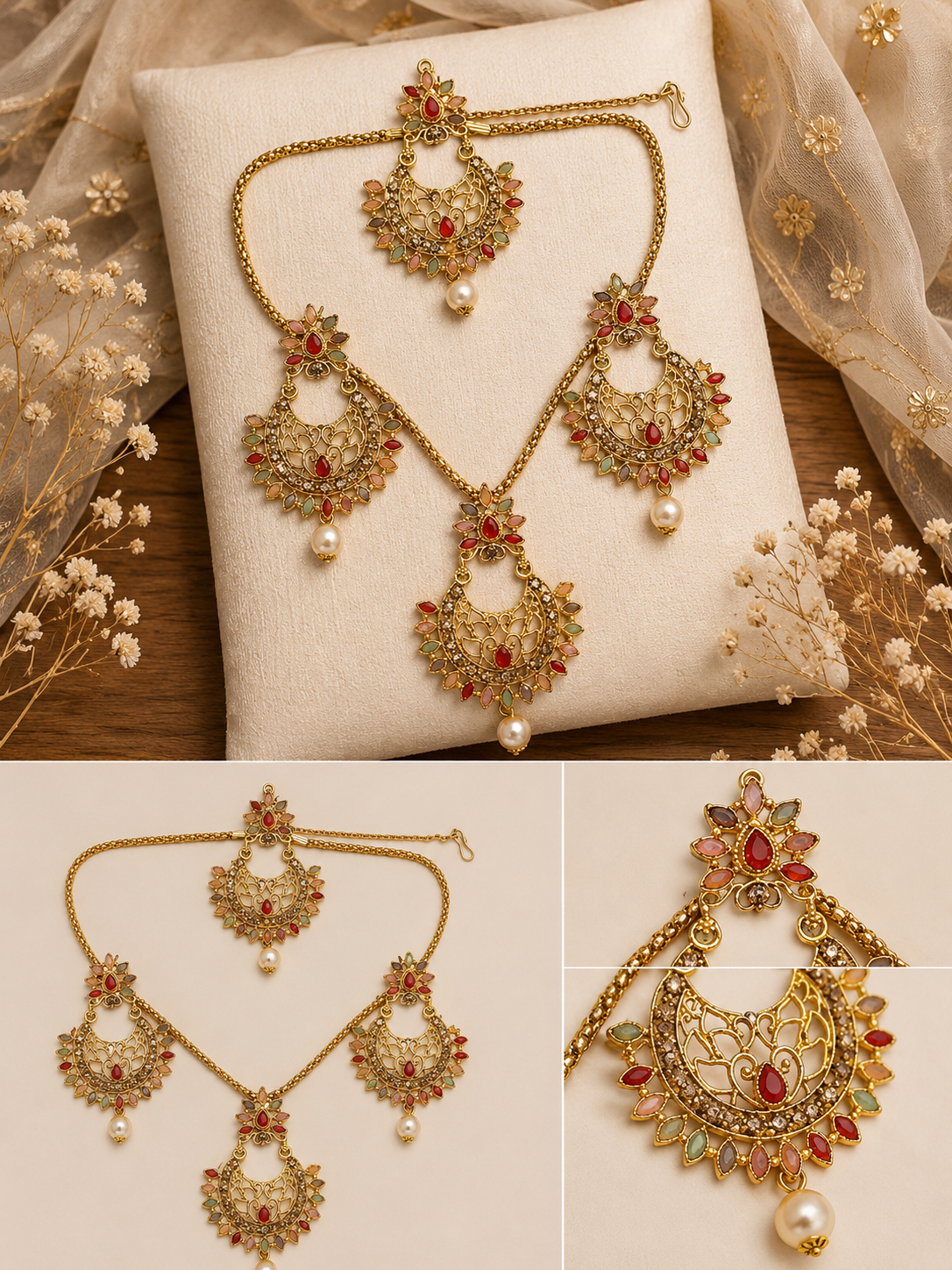 Gold-toned traditional Indian jewelry set with a necklace, earrings, and maang tikka, decorated with red stones, green stones, and white pearl beads, displayed on a cream cushion and fabric background.