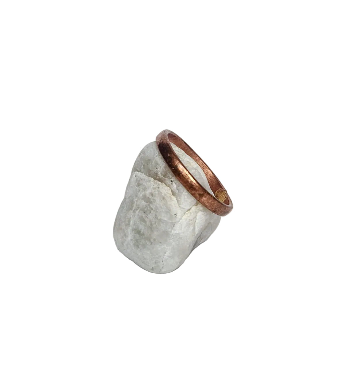 Ring with a textured stone design and copper band on a white background