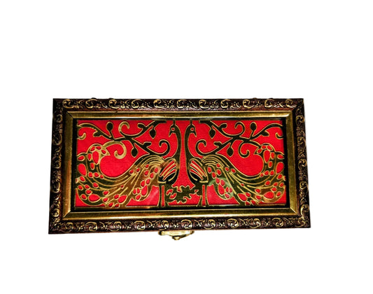 Decorative box with red and gold design on a white background