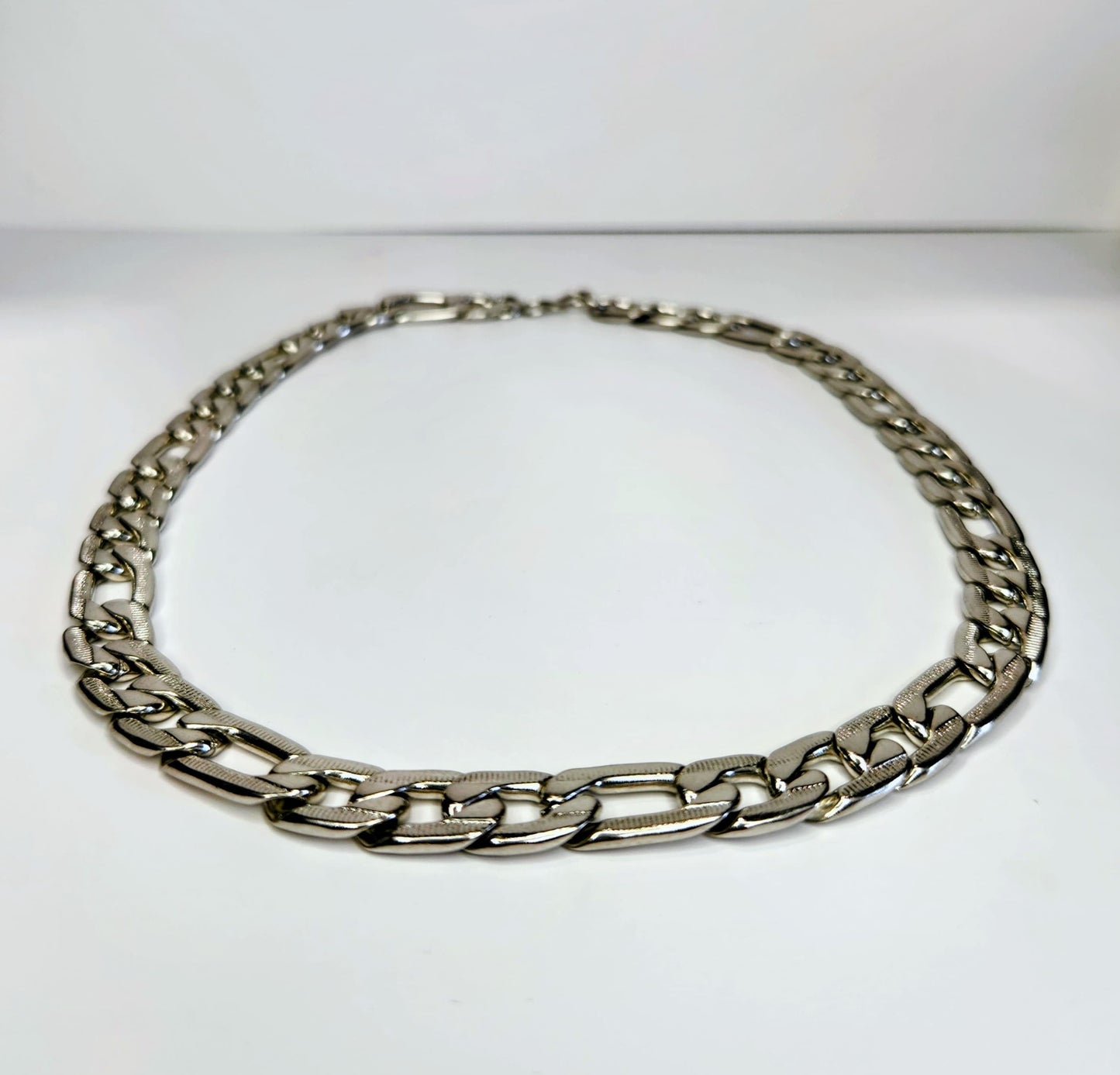 Silver chain necklace on a white background